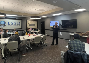 a man presenting in front of people